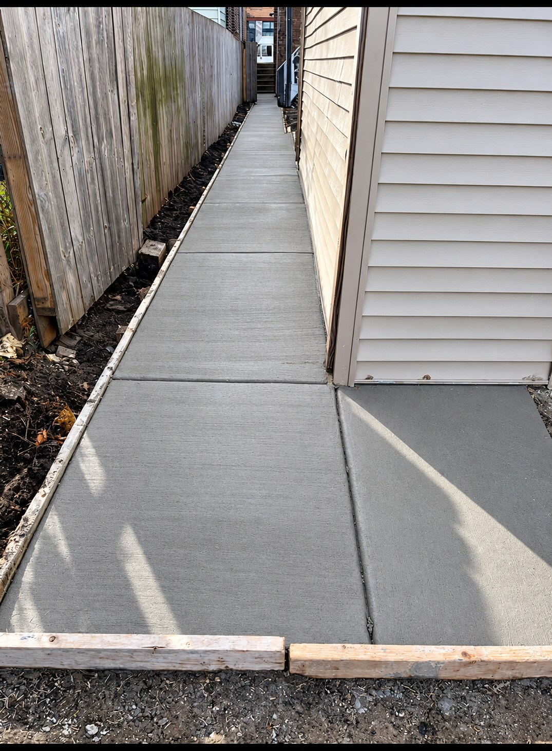 New concrete side walk along a home