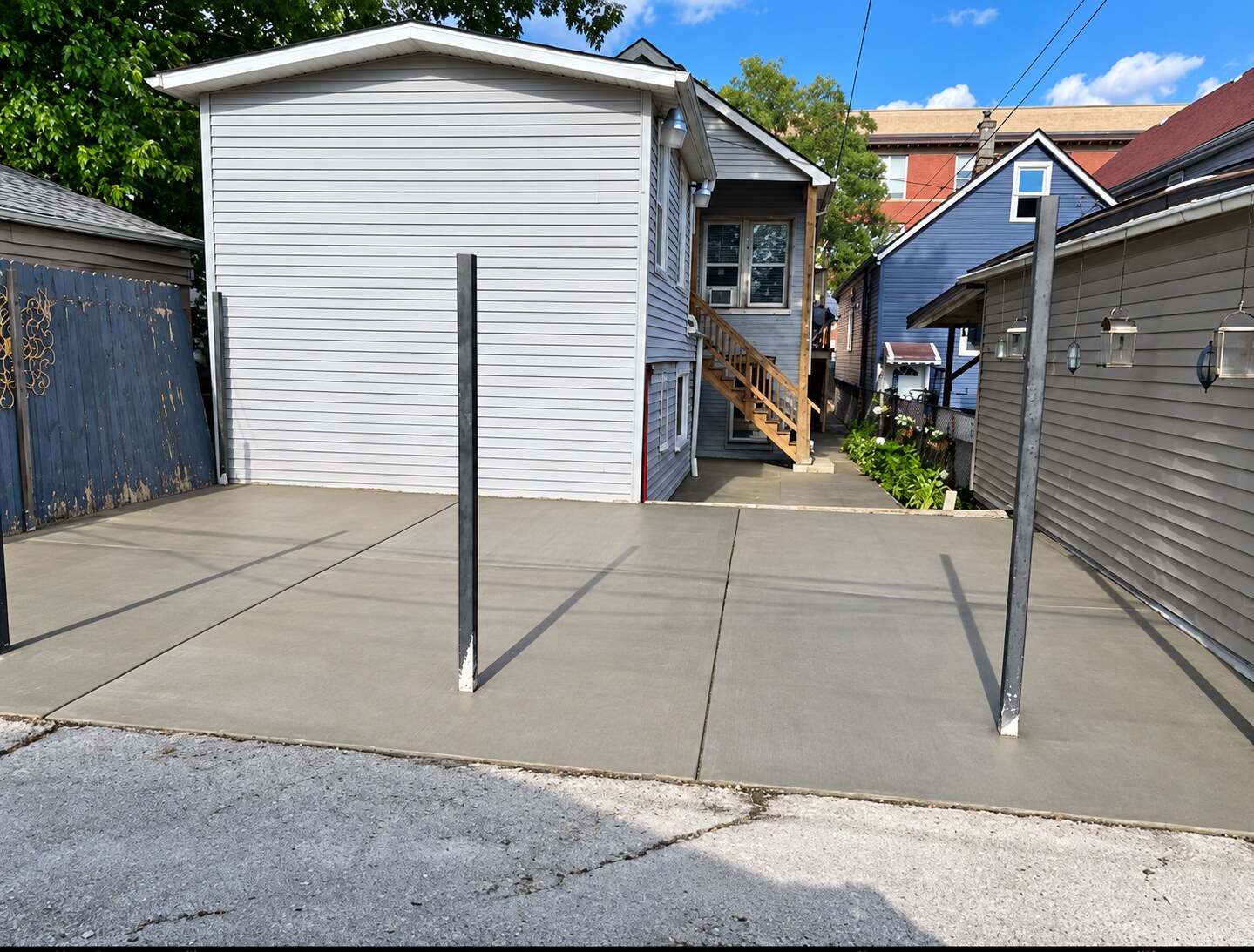 Fresh concrete pad between neighboring homes