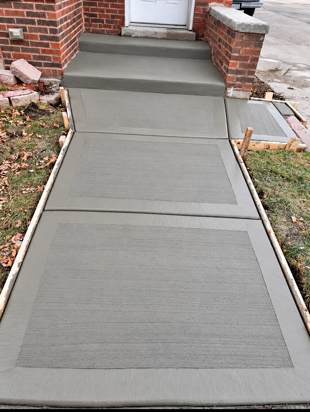 Concrete front walk leading to home entry steps