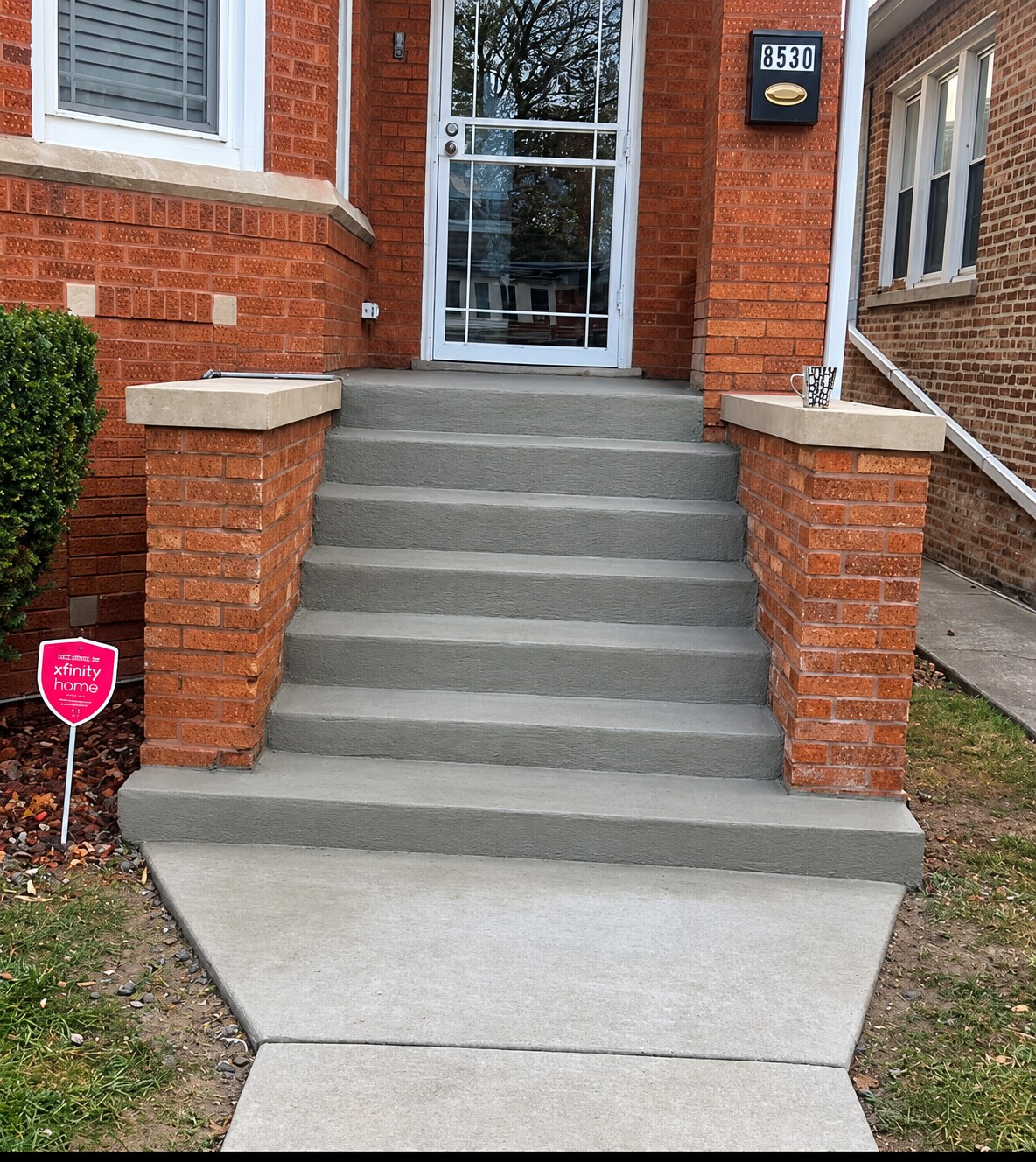 Finished concrete steps and landing at a brick Chicago home